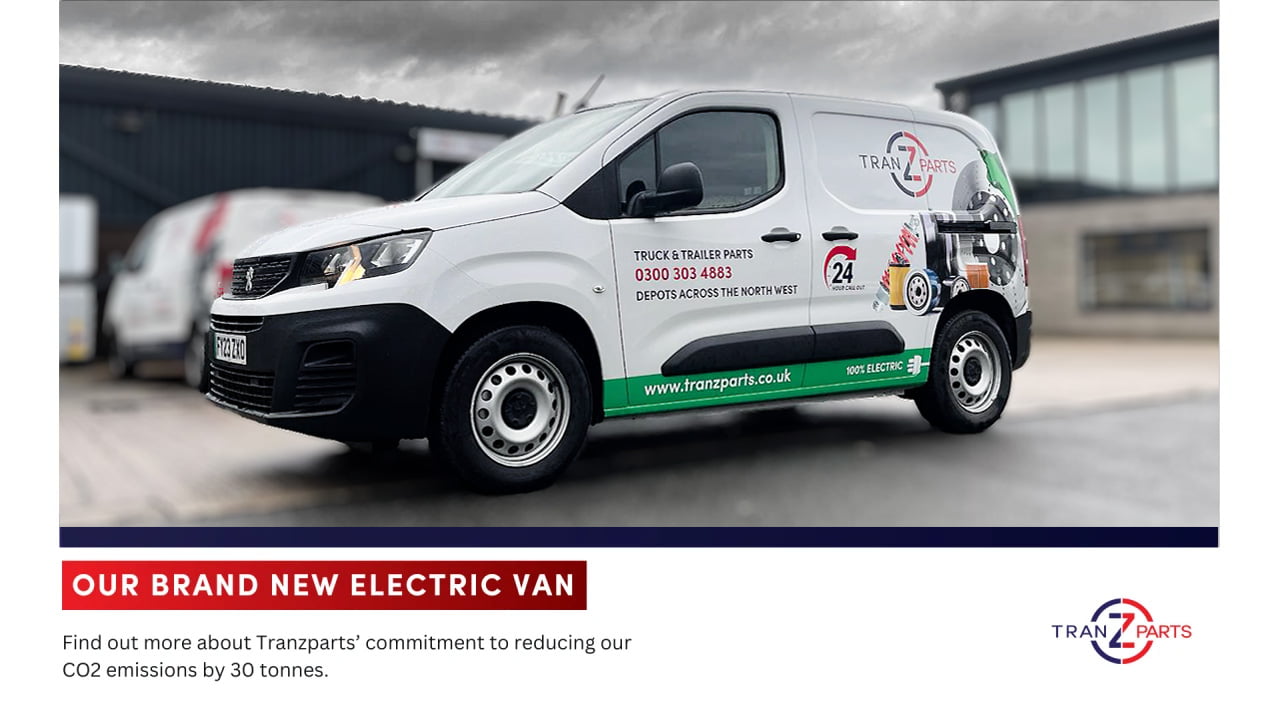 Inaugural Tranzparts electric van parked outside headquarters with charging station